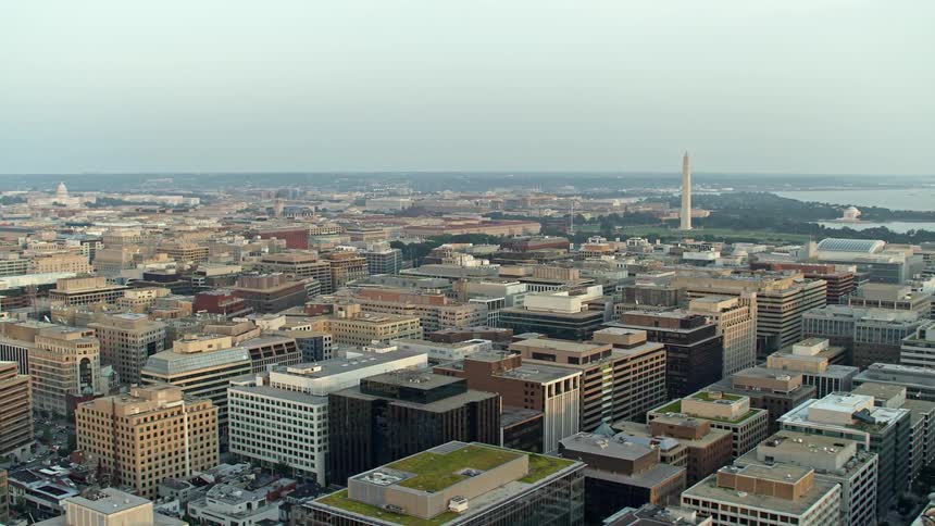 A beautiful aerial shot of Washington Monument and Jefferson Memorial during sunset captured from above the city skyline