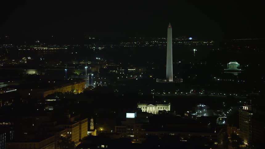 A stunning aerial view of the White House and Washington Monument in Washington DC at night with the Jefferson Memorial revealed