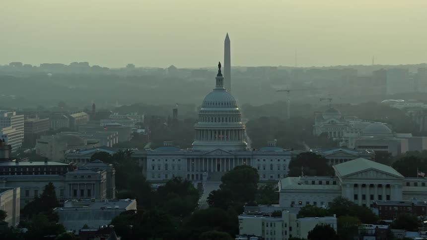 Aerial view of the United States Capitol and the Washington Monument during sunset in Washington DC