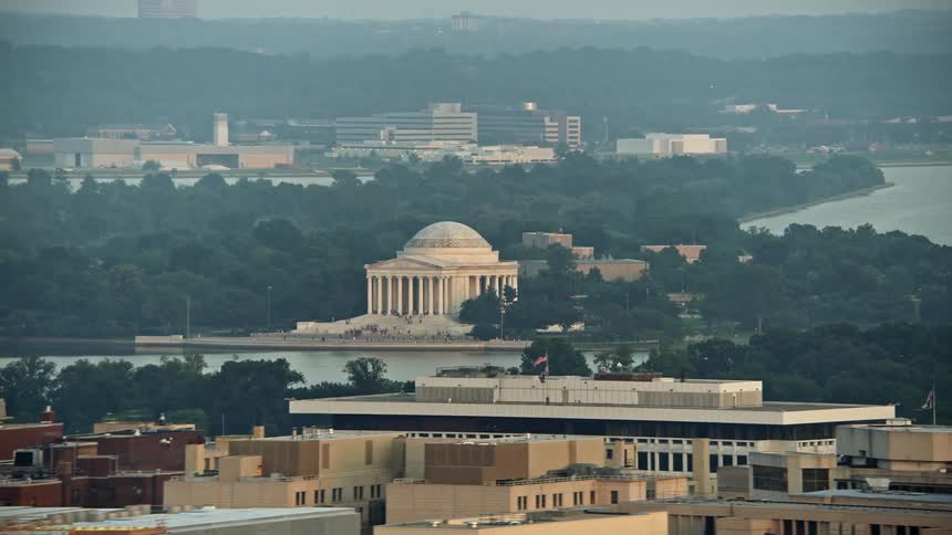 Tourists gather at the Jefferson Memorial in Washington DC during a vibrant sunset captured in stunning aerial footage