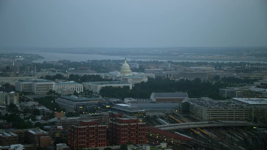 Aerial view of United States Capitol during twilight with Potomac River in the background Washington DC