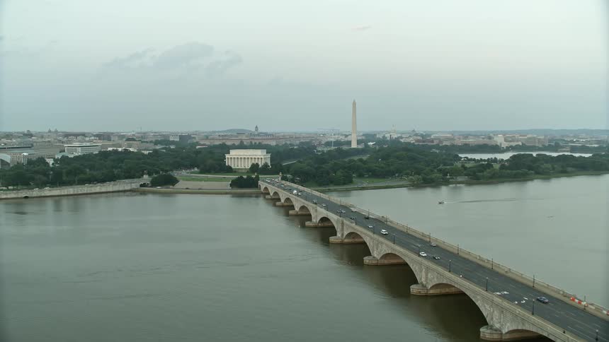Aerial footage of Lincoln Memorial and Washington Monument seen from Arlington Memorial Bridge during twilight in Washington DC