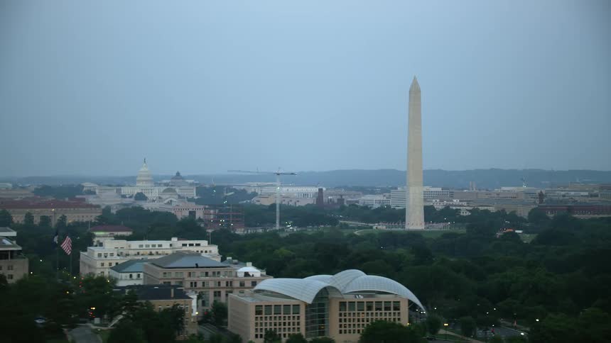 A stunning aerial view at twilight of the iconic Washington Monument United States Capitol and Lincoln Memorial in Washington DC