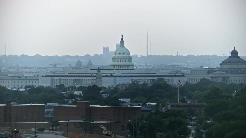 Aerial footage of the United States Capitol dome and James Madison Building in Washington DC during twilight