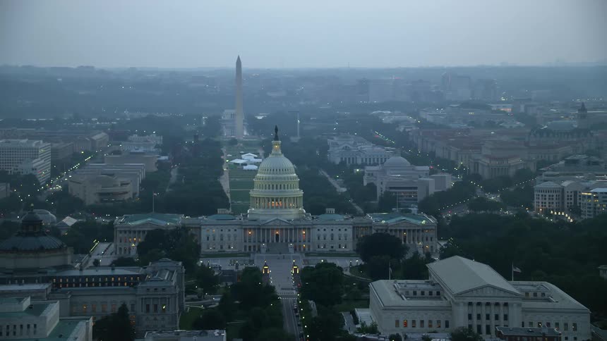 Aerial footage of the United States Capitol Washington Monument and the Thomas Jefferson Building at dusk in Washington DC