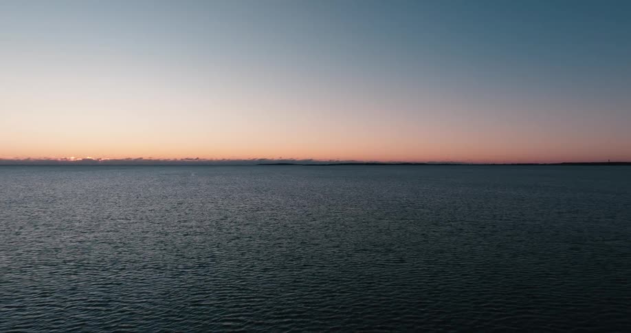 Aerial view of the surface of the ocean at evening