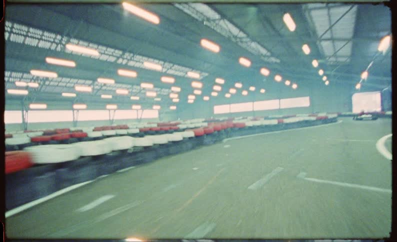 A pov of looking out through a moving vehicle is moving through a race track at a very high speed