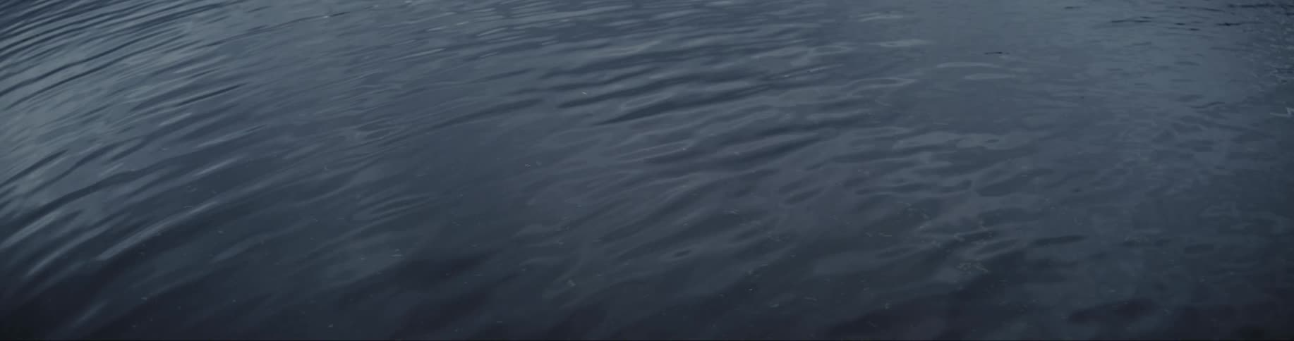 Light shines on the water as it ripples and moves