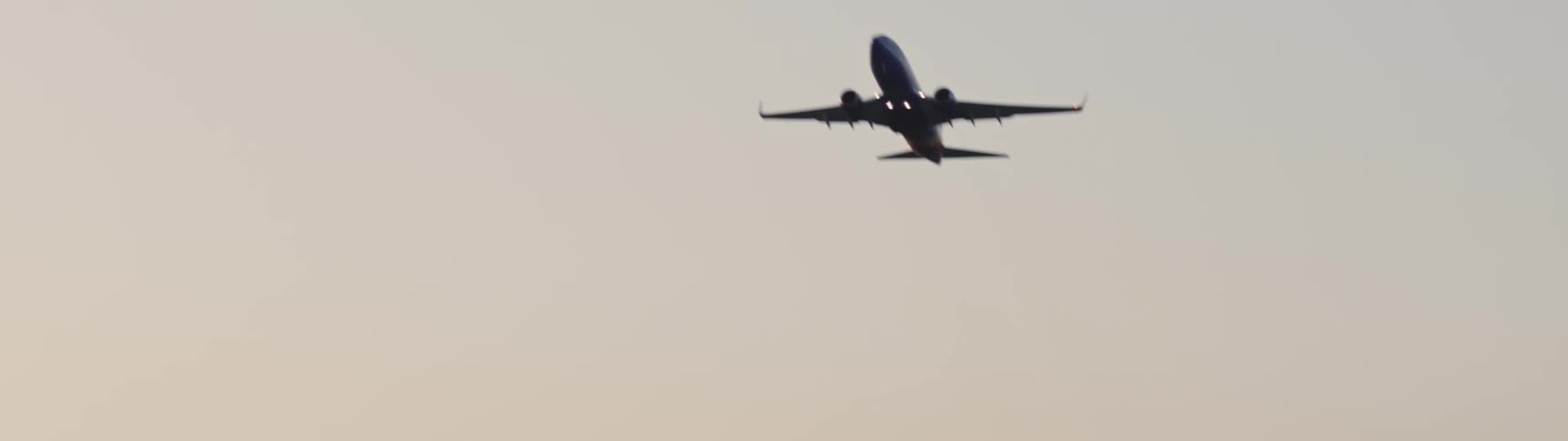 An airplane taking flight against a clear sky