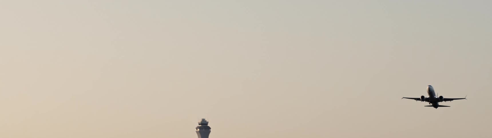 An airplane taking off from an airport on a foggy day