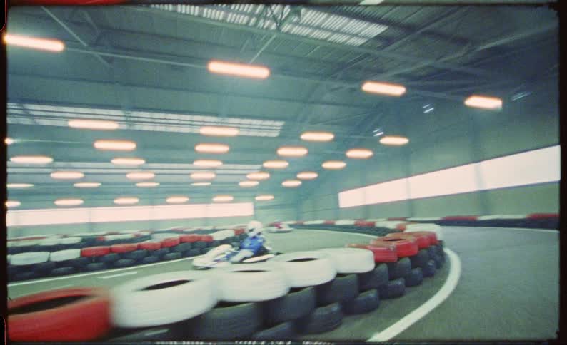 Point of view footage driving a go cart on an indoors track