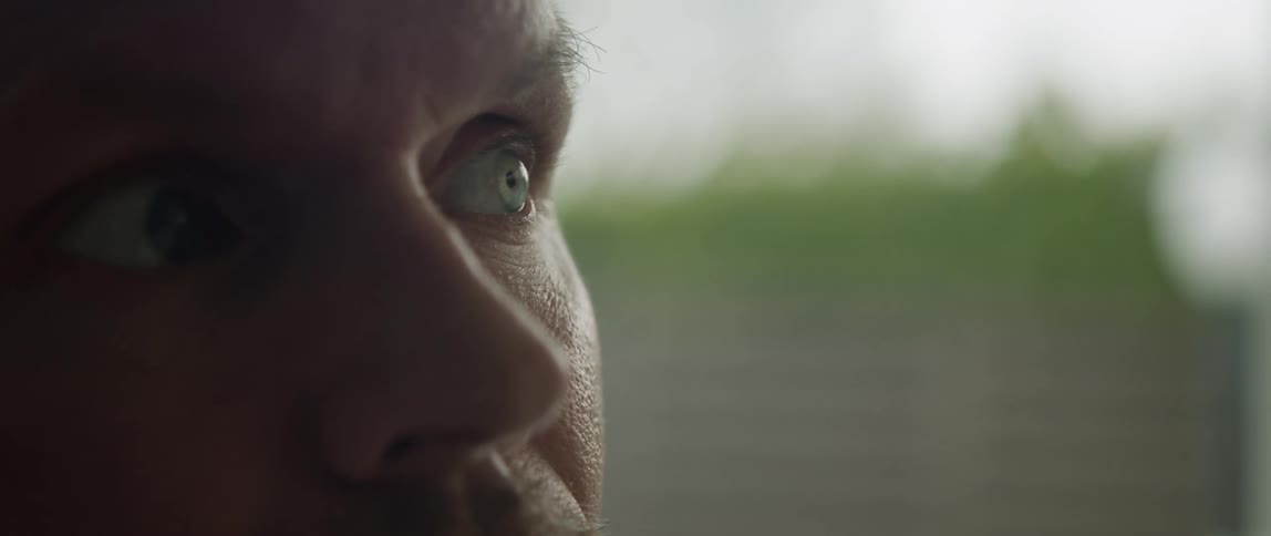 A man stares unblinkingly at something out of frame