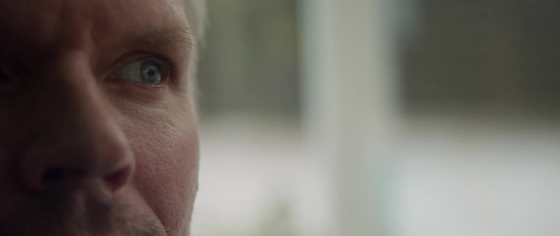 Close up view of a mans face is displayed
