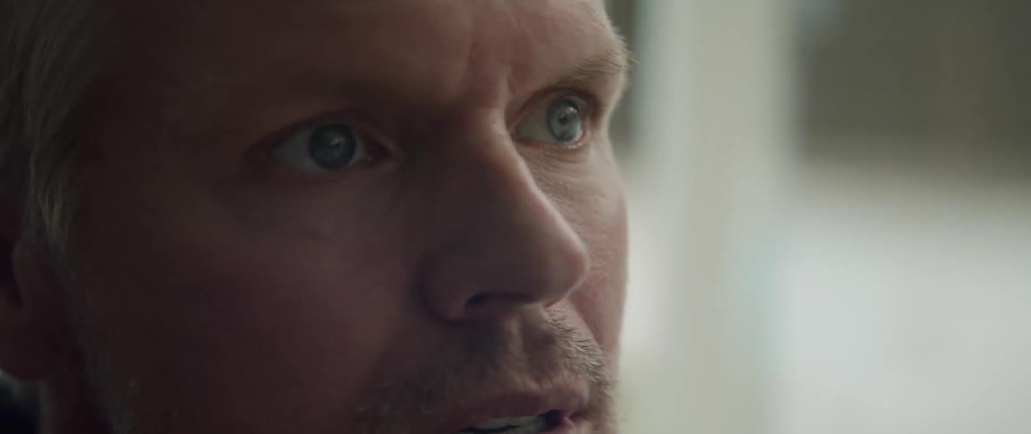 Man compresses his mouth while staring to the side
