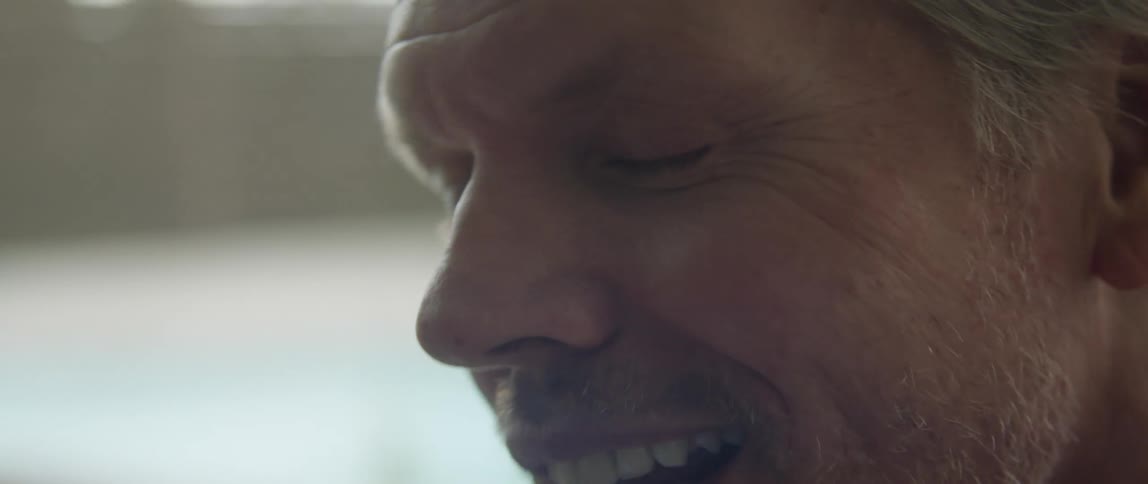 Close up of the face of a happy man talking and laughing