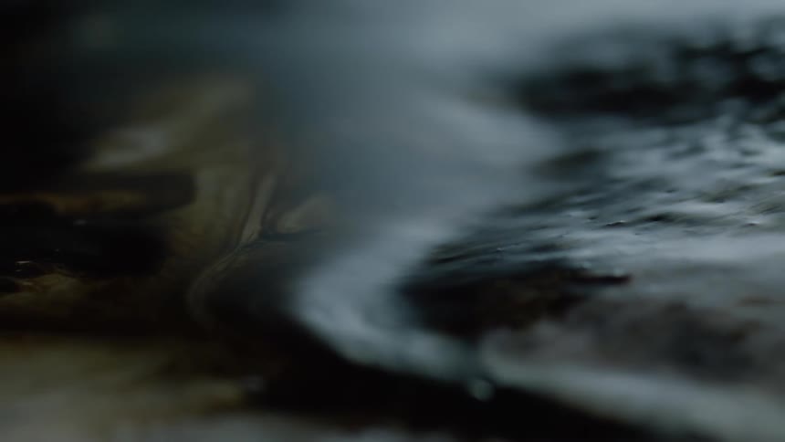 Close up of black slimy magnetic putty moving and rising in spikes
