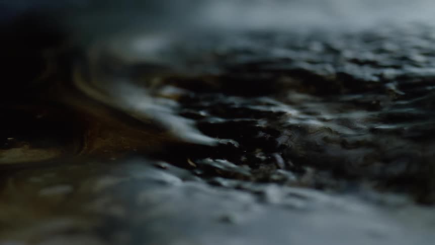 Close up of black slimy magnetic putty moving and rising in spikes