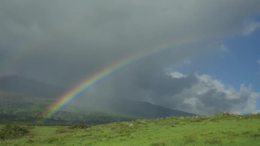 A rainbow over a hilly countryside