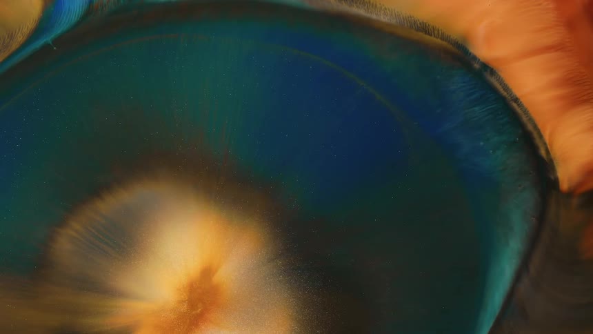 Turquoise and orange paint spreading out from the center