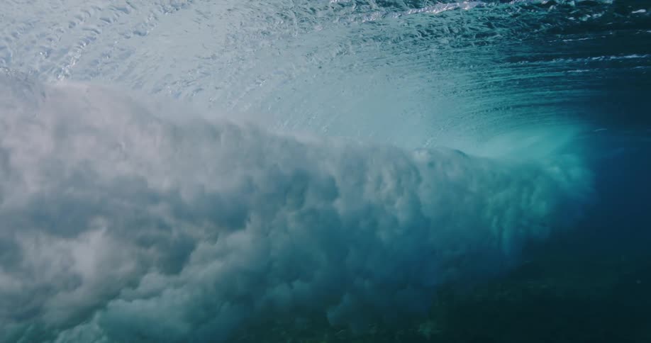 A large swirled wave moves through the ocean