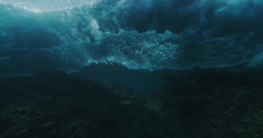Waves moving foward with rocks under the water