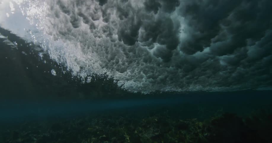 A large wave crashes in the ocean