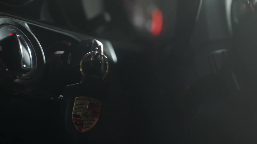 A man turns the key to start his vehicle