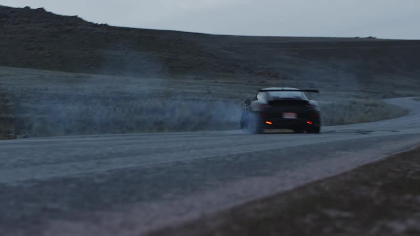 A car is driving off road in a rural area