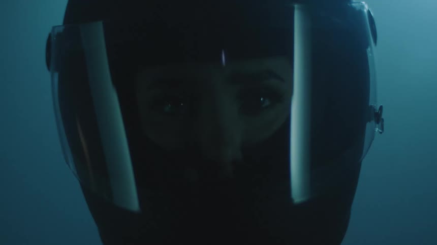 Sad and frightened woman stares at camera