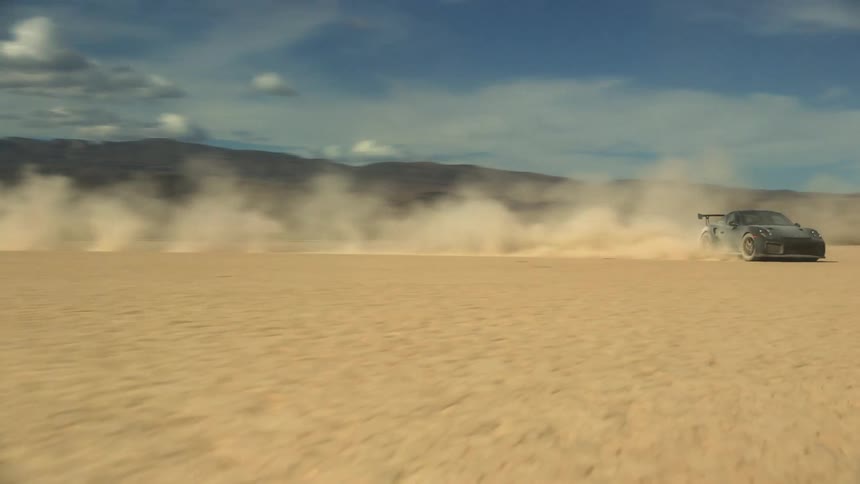 A car is driving off road in a desert area
