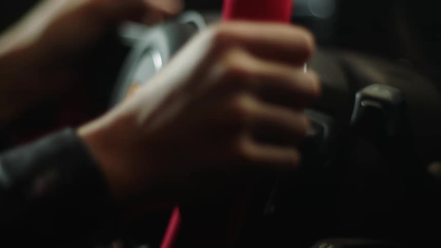A person is steering the wheel of a car