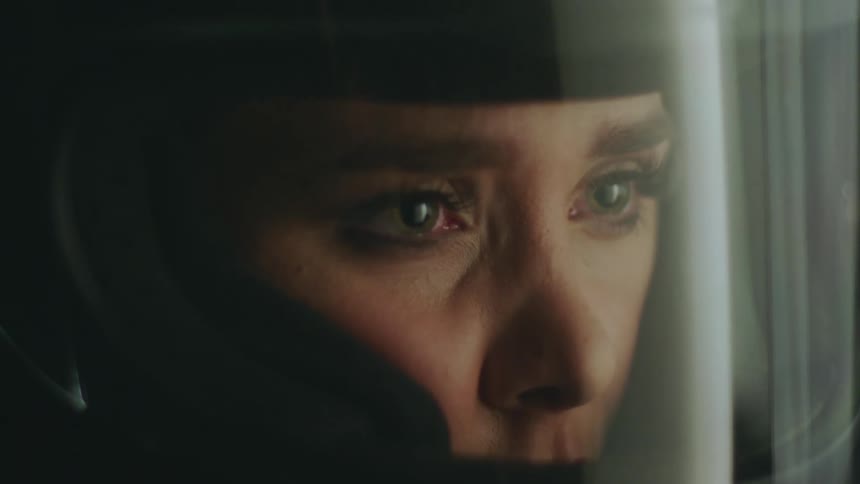 A woman wears a crash helmet with a clear protective window