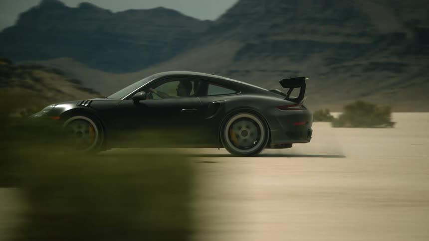 The car is driving in the desert