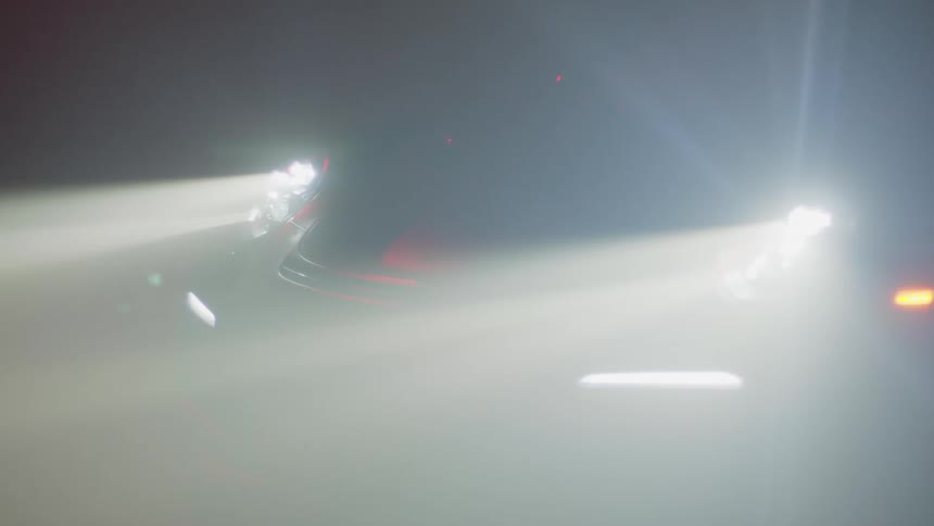 The cars headlights come on in the dark