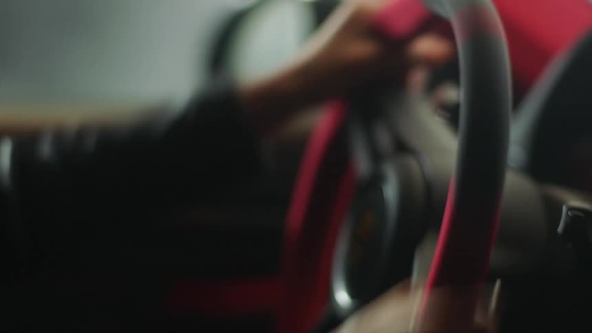 A woman is driving a car and wearing a helmet
