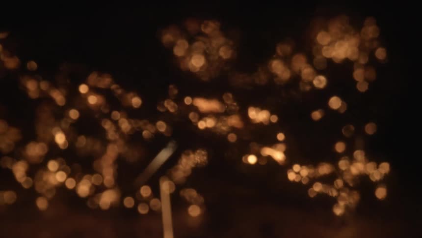 Sparks and light flares in the distance at night