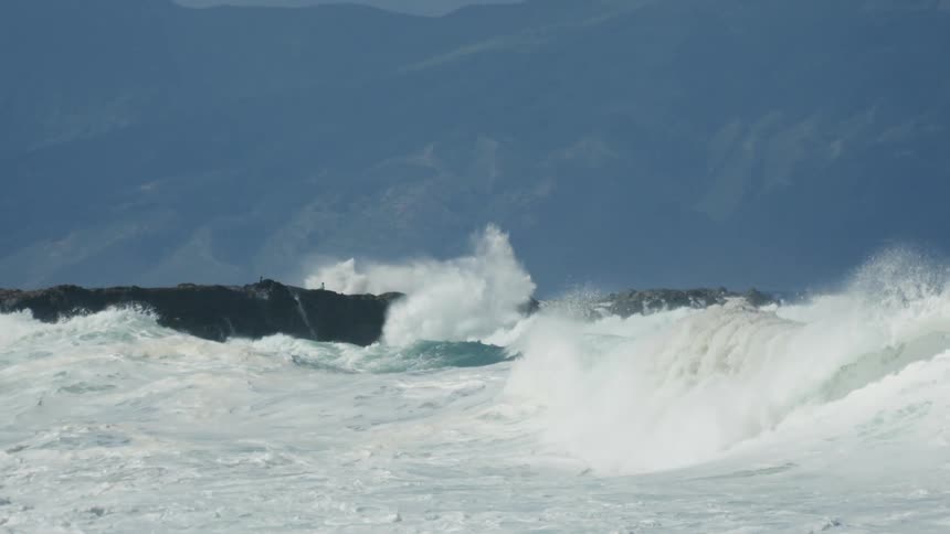 Ocean waves crash against the shore