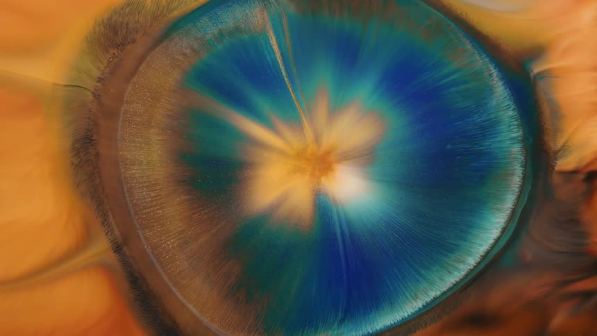 A mix of gold, blue and turquoise paint spreading out from the middle