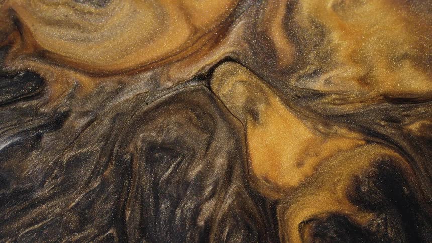 A sparkling substance in shades of gold mixes and darker tones swirl as they move in