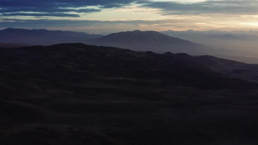 Landscape of mountains being silhouetted against the sky at dusk