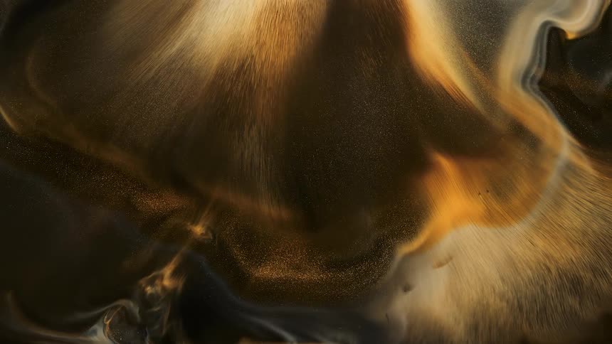 Brown and gold paints combine together to create a swirl pattern