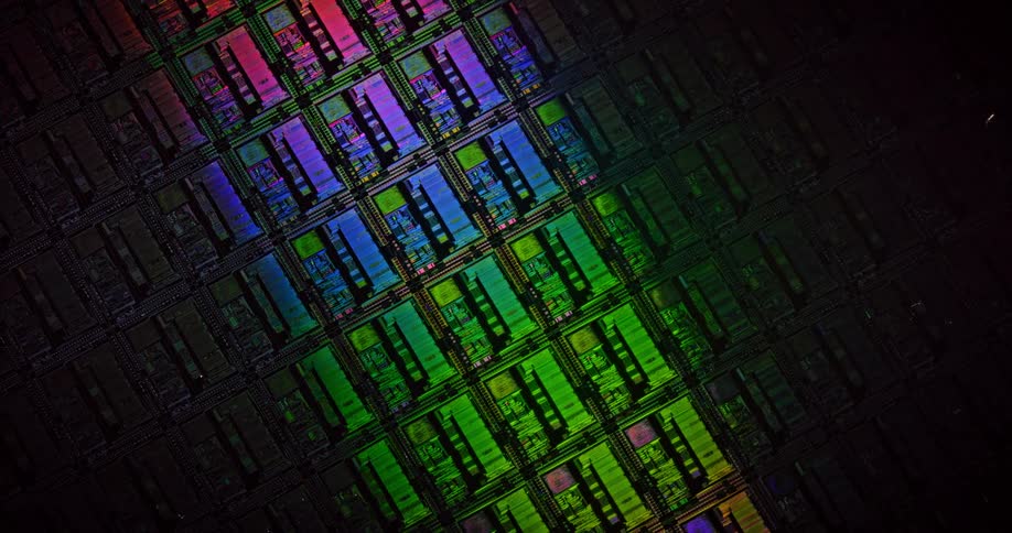 Rainbow colored lights shine over a circuit board