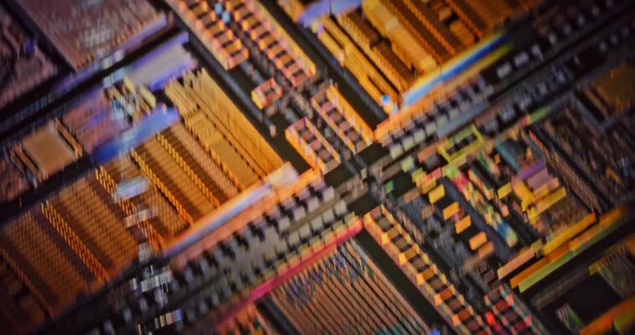 Extreme close up of moving microchips on a printed circuit board reflecting light