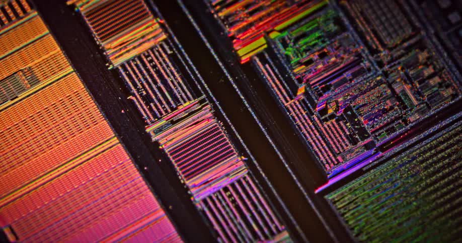 Extreme close up of moving microchips on a printed circuit board reflecting light