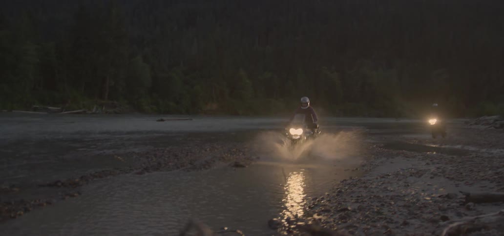 Motorcyclists riding through puddles