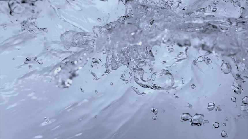 Water is splashing and reflecting in the light as it moves