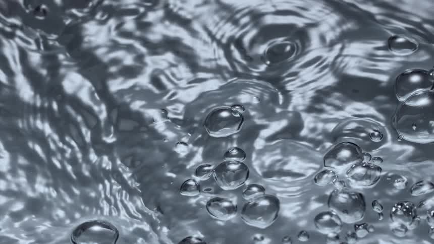 Water moves and sparkles as bubbles rise to the surface