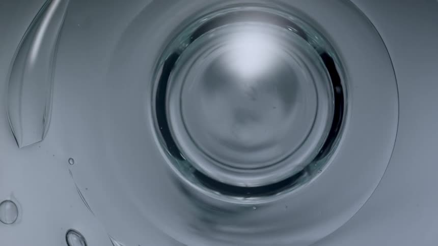 Abstract footage of water forming symmetric bubbles in formation