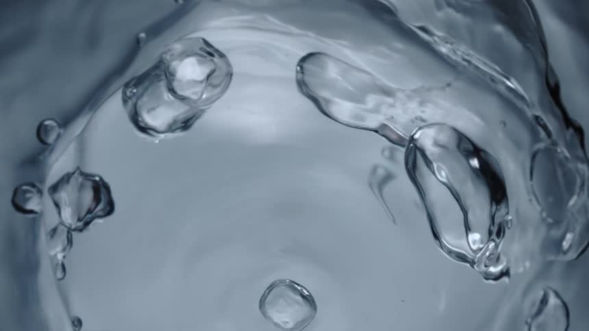 A water bubble expands and explodes in water
