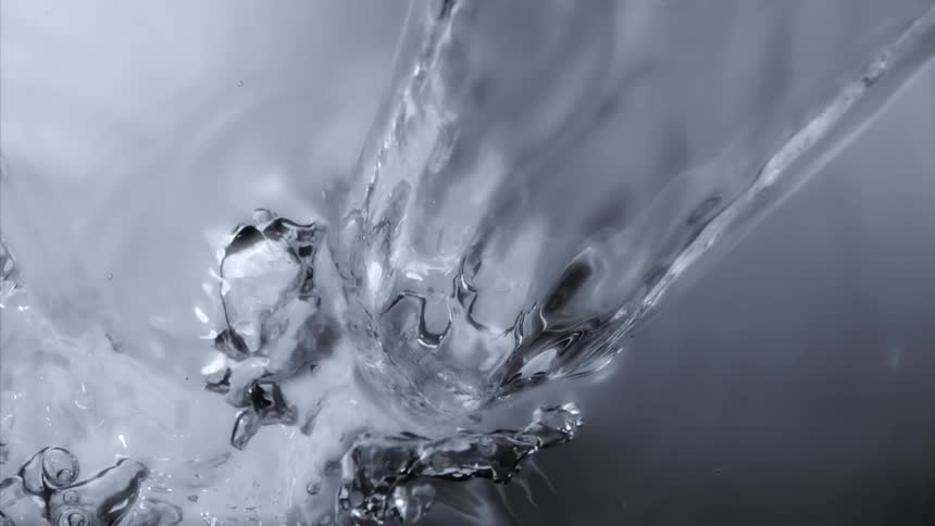 Clear clean water is poured causing the surface to ripple